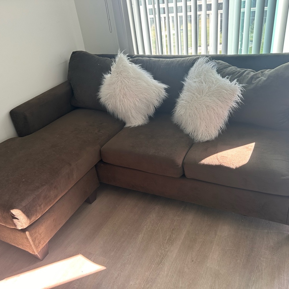 Brown Sectional Sofa with Cream Accent Pillows